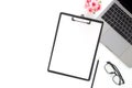 Creative flat lay photo of workspace desk. Top view office desk with laptop, glasses, pencil, blank clipboard and plant on white