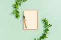 Creative flat lay photo of workspace desk. Top view office desk with open mockup blank notebooks and pencil and plant on pastel Royalty Free Stock Photo