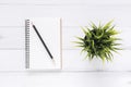 Creative flat lay photo of workspace desk. White office desk wooden table background with mock up notebooks and pencil and plant. Royalty Free Stock Photo