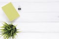 Creative flat lay photo of workspace desk. White office desk wooden table background with mock up notebooks and plant. Royalty Free Stock Photo