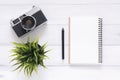 Creative flat lay photo of workspace desk. White office desk wooden table background with mock up notebooks and retro camera. Royalty Free Stock Photo