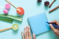 Creative flat lay of skincare and healthcare concept. Woman`s hands with empty notebook, tomato, aloe vera and lime