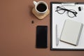 Creative flat lay, top view office table desk. Workspace with blank clip board, office supplies, pen, notepad, smartphone, glasses Royalty Free Stock Photo