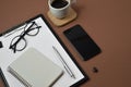 Creative flat lay, top view office table desk. Workspace with blank clip board, office supplies, pen, notepad, smartphone, glasses Royalty Free Stock Photo