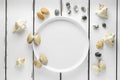 White plate with seashells on white wooding background, wallpaper top view Royalty Free Stock Photo