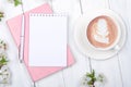 Creative flat lay of workspace desk, notepad on wooden background