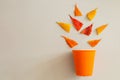 Creative flay lay of orange cup and leaves