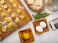 Creative food collage. Appetizing homemade dumplings are waiting to be cooked. Fragrant sprigs of rosemary, ingredients and Royalty Free Stock Photo