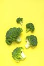 Creative food concept. Fresh raw green broccoli on yellow background. Healthy vegetables, diet vegan organic food, vitamins. Flat Royalty Free Stock Photo