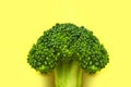 Creative food concept. Fresh raw green broccoli on yellow background. Healthy vegetables, diet vegan organic food, vitamins. Flat Royalty Free Stock Photo