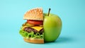 Creative food concept with half hamburger half green apple on blue background Royalty Free Stock Photo