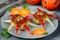 Creative food idea for kids - meatballs with colorful bell pepper shaped funny spider garnish pumpkin slice Royalty Free Stock Photo