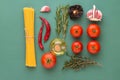 Creative food poster with flat lay knolling of Italian arrabiata pasta ingredients. Spaghetti tomatoes hot chili peppers herbs oil