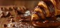 Close up of Croissant bread drizzle with chocolate syrup with liquid droplet splash and cocoa pieces on brown background