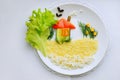 Creative food on White plate. Composition of vegetables. Art on kitchen. Funny meal for Kids. Royalty Free Stock Photo