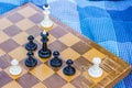 Creative foreshortening from above chess concept with wooden desk with black and white figures on game space and lay near on Royalty Free Stock Photo