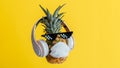 Creative funny pineapple face wearing glasses headphones and protective medical mask. Resting levitating pineapple face Royalty Free Stock Photo