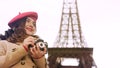 Creative girl holding camera in hands, enjoying photography hobby in Paris