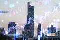 Creative glowing candlestick forex chart on city buildings wallpaper. Technology, trade and financial data concept. Double