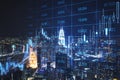 Creative glowing forex chart grid and big data hologram on blurry night city wallpaper. Trade, technology and finance concept. Royalty Free Stock Photo