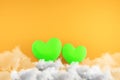 Creative green hearts on orange background