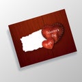 Creative greeting card design with stitched heart shape on wooden texture background.