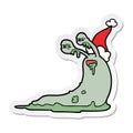 A creative gross sticker cartoon of a slug wearing santa hat