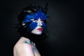 Creative Halloween character. Woman bird makeup on dark background Royalty Free Stock Photo
