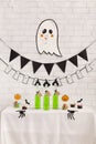 Creative halloween concept with cute ghost above table