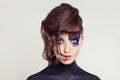 Creative Halloween makeup character. Woman with art makeup and hairstyle on white