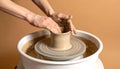 Creative hands shaping clay on a spinning pottery wheel in the studio for art class Royalty Free Stock Photo