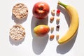 Creative healthy breakfast concept white background flat lay.Cheese,calcium rich food,nut, fruit, whole grain crispbread