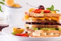 Creative healthy burger filled with sliced fresh tropical fruits, strawberries and cherry. Healthy eating concept