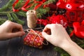 Creative hobby. hands wrap christmas holiday handmade present in craft paper with twine ribbon