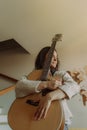 Creative hobby. Talented young female musician sit in armchair alone compose instrumental song using classic guitar. Copy space