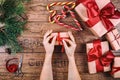 Creative hobby. Woman's hands show christmas holiday handmade present in craft paper with ribbon. Making bow at xmas Royalty Free Stock Photo