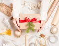 Creative hobby. Woman`s hands wrap christmas holiday handmade present in craft paper with twine ribbon. Making bow at xmas gift b Royalty Free Stock Photo