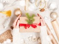 Creative hobby. Woman`s hands wrap christmas holiday handmade present in craft paper with twine ribbon. Royalty Free Stock Photo