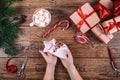 Creative hobby. Woman's hands show christmas holiday handmade Christmas tree toy. Scissors on wooden table, top view Royalty Free Stock Photo