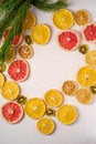 Creative holiday Christmas New Year food fruit texture with dried grapefruit, kiwi, orange and lemon with branch of fir tree Royalty Free Stock Photo