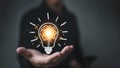 Creative idea concept. Businessman holding light bulb and brain inside. innovation technology, inspiration for business or Royalty Free Stock Photo