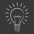 Creative idea concept. Light bulb illuminated hand-drawn on a blackboard illustration.