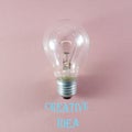 Creative idea and innovation concept via lit bulb on pink background and relevant text Royalty Free Stock Photo