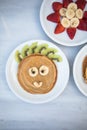 Creative idea for kids breakfast. Bear shaped pancakes with berries on marble  table, top view. Healthy food for children. Funny Royalty Free Stock Photo
