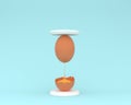Creative idea layout egg hourglass on pastel blue background. mi Royalty Free Stock Photo