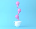 Creative idea light bulb pink floating with cup on pastel blue background. minimal business ideas concept Royalty Free Stock Photo