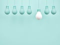 Creative idea light bulb symbol on simple pastel blue background with different idea design concept. Royalty Free Stock Photo