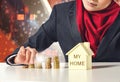 Successful young muslimah saving money for her dream house over abstract double exposure background Royalty Free Stock Photo