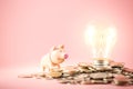 Creative ideas of saving money concept with lightbulb and piggy bank on coins pile. Business planning for the future Royalty Free Stock Photo