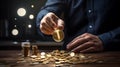 Creative Illumination: Hand Grasping Light Bulb Amid Coins on Desk Royalty Free Stock Photo